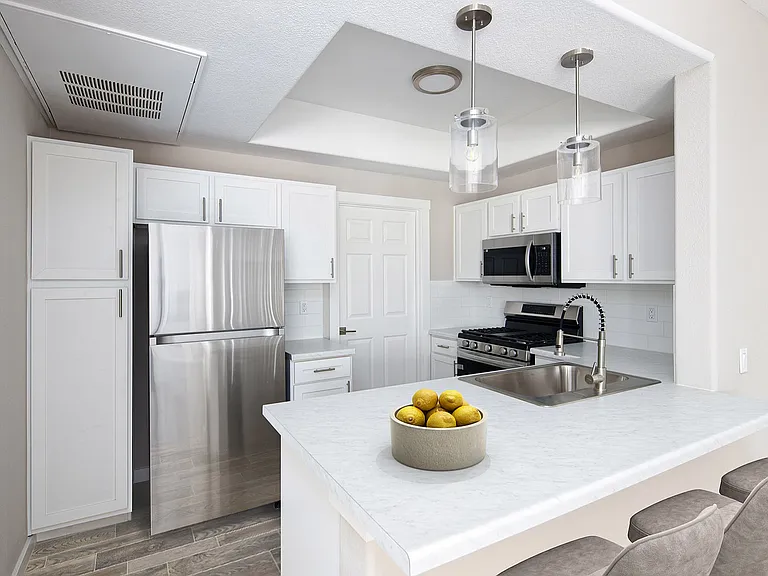 Experience the elegance of this modern kitchen, equipped for both style and functionality.