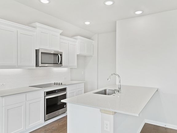 Kitchen in the Nobel home plan by Trophy Signature Homes - REPRESENTATIVE PHOTO