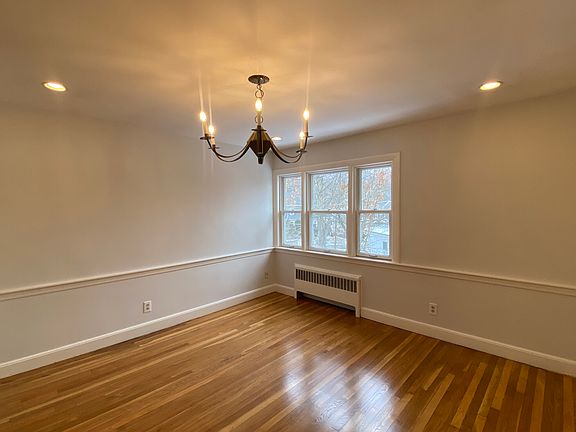 Dining room off of kitchen~ Large windows offer lots of sunlight. Gleaming hw flooring throughout~ kitchen has laminate flooring.