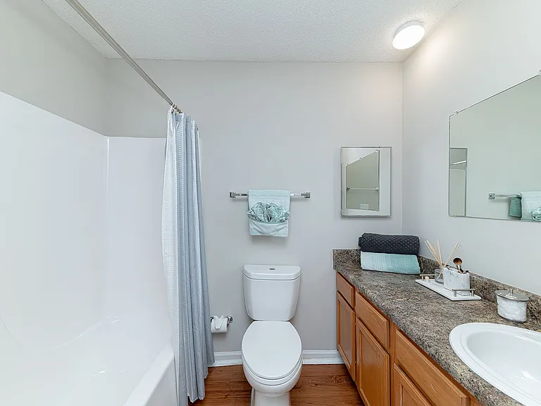 Bright bathroom with bathtub and ample counterspace