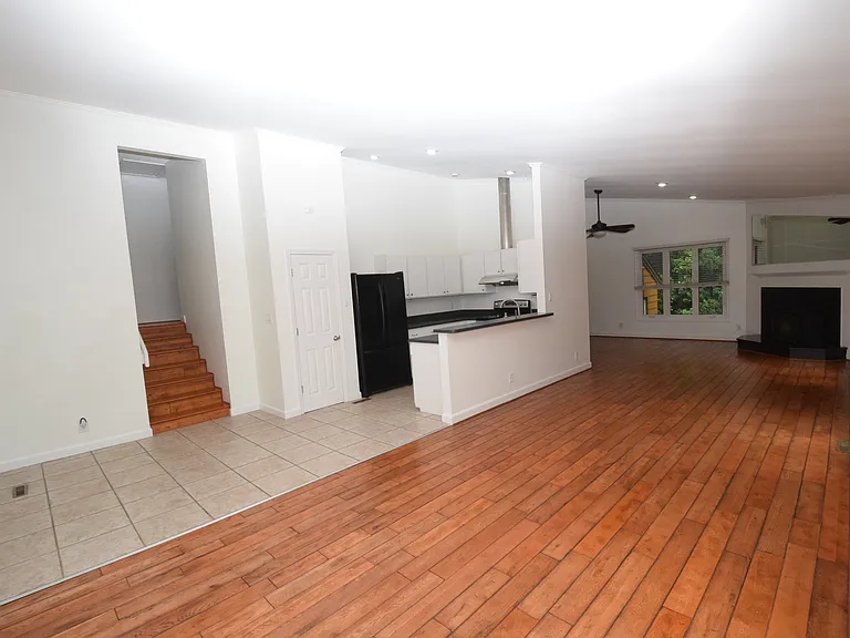 Another Section of main living area with kitchen on left and 2nd stairway up to owner's quarters.