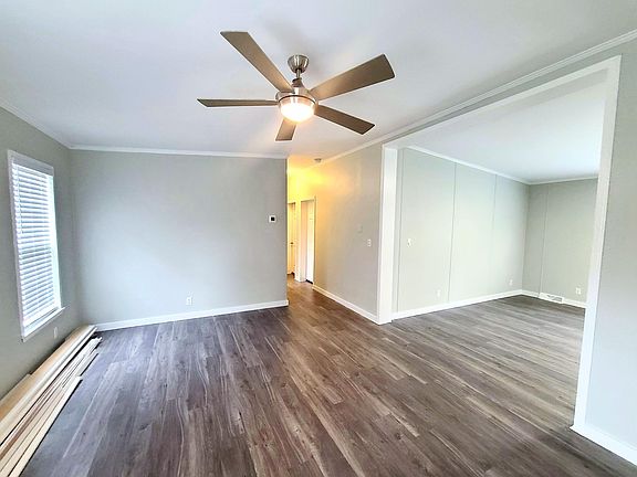 Open living room, with cathedral ceilings leads to large dining area