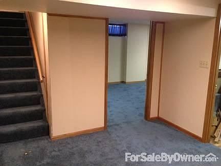 Basement room at bottom of steps
						:
						Looking towards the larger room; stairs to the left and washroom to the right.