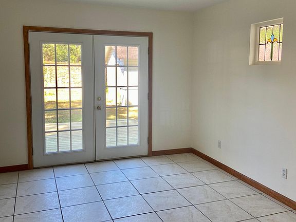 "Bonus" room with custom stained glass window and French doors that open to the spacious backyard.