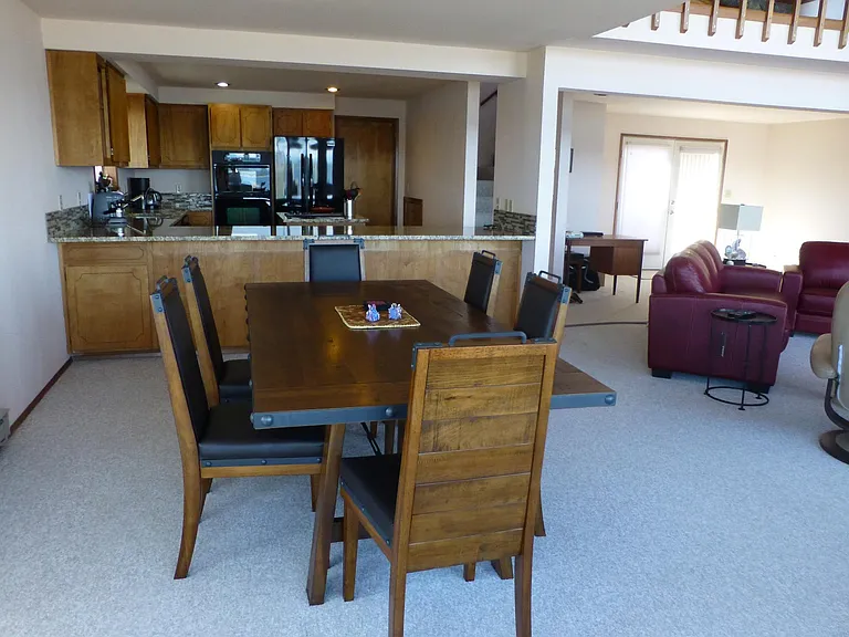 Beautiful rustic-look dining table and leather chairs. Two more chairs are not shown in picture.