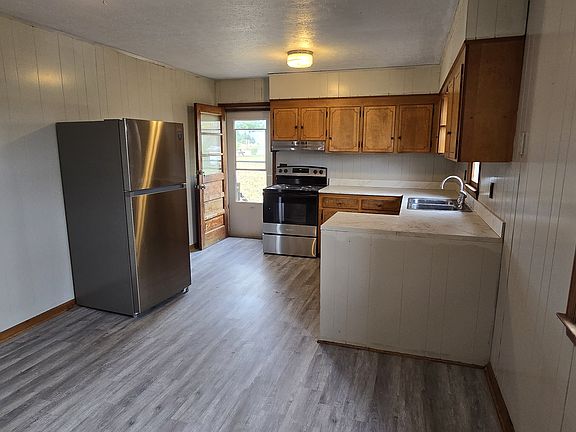 standing in the spacious dining area looking toward side entrance