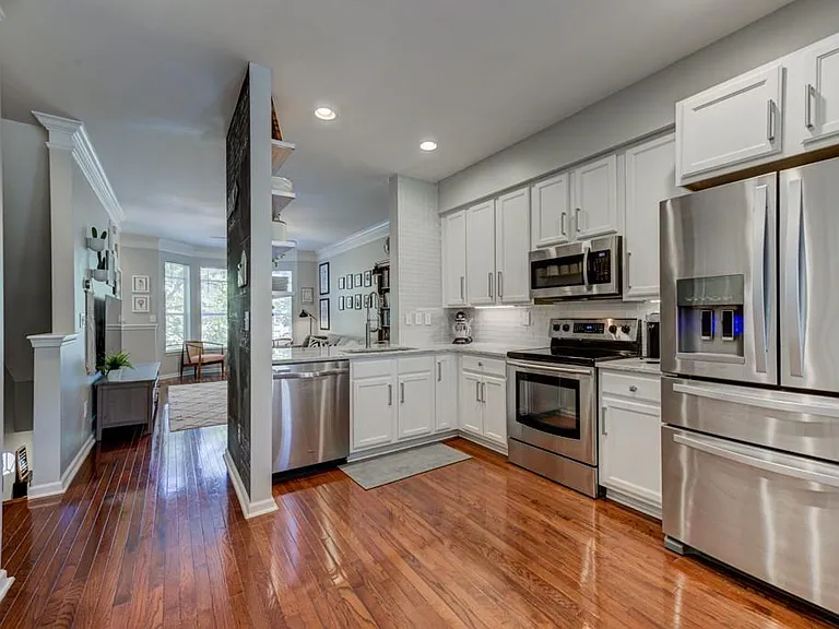 Kitchen, pantry door on the left with complete shelving unit.