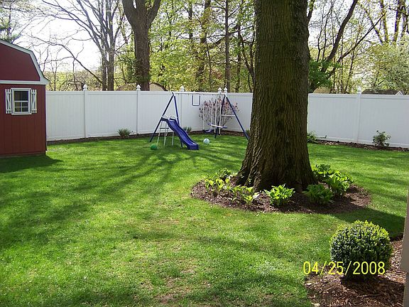 fenced in backyard with bnew shed on concrete foundation