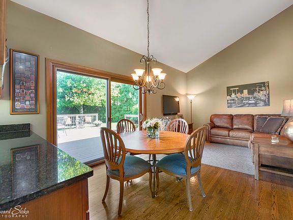 KITCHEN EATING AREA OPEN TO HEARTH ROOM AND ACCESS OUT TO YOUR PRIVATE DECK