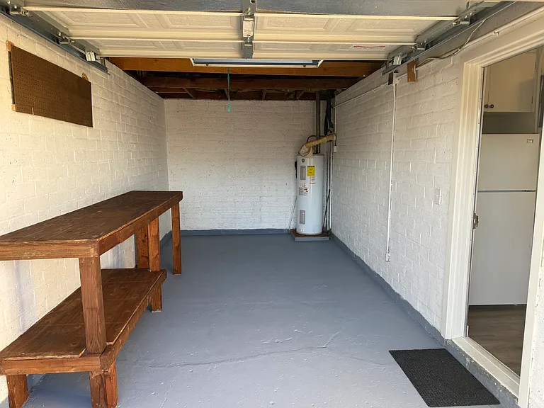 Garage, workbench can be removed to make space for a vehicle.