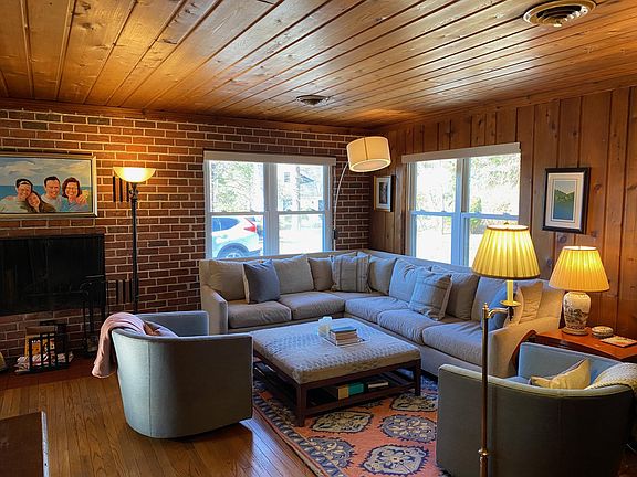 Spacious living room on main floor with ample seating and large windows.