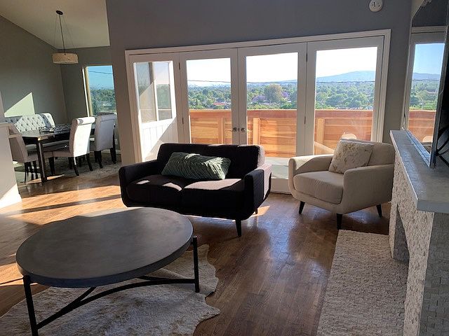 Open floor plan living room with city views, high vaulted ceilings