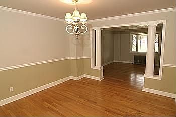 Dining Room with Pillars, Chair Molding, and Crown Molding