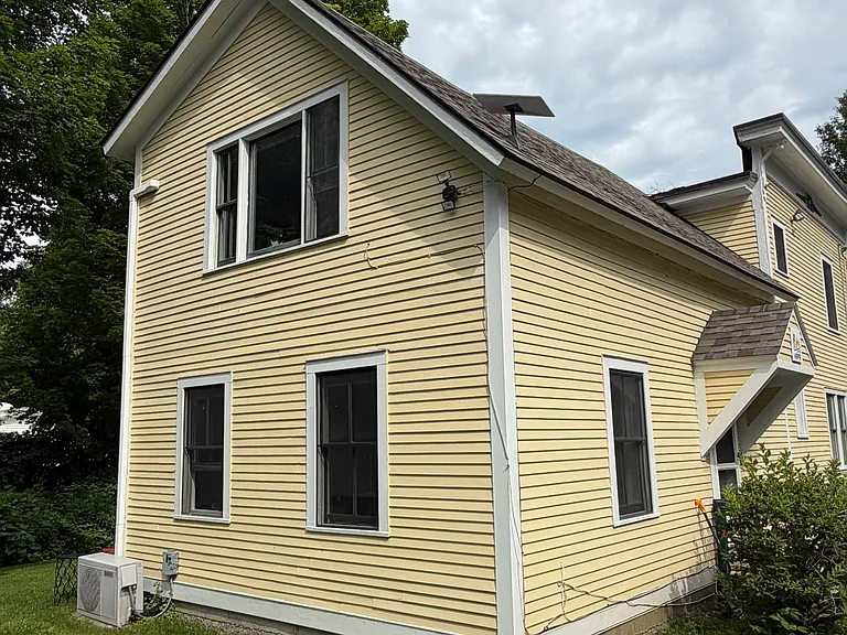 Exterior, this is the South side. Lots of light pours into these windows. All first floor windows have blackout shades installed.