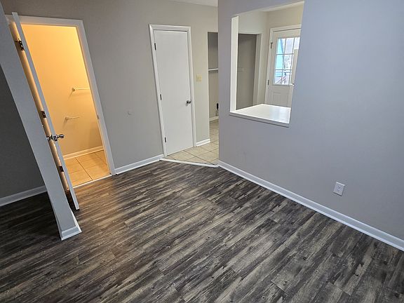 dining area showing door to half bath and entrance to kitchen