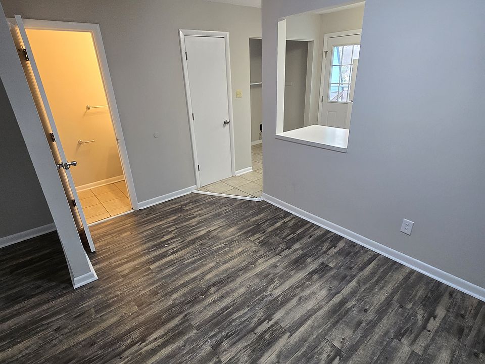 dining area showing door to half bath and entrance to kitchen