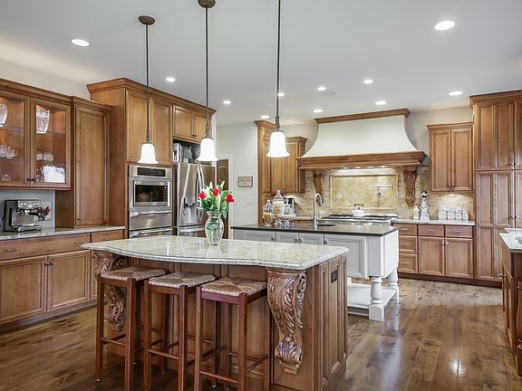 Stunning kitchen with double granite islands makes