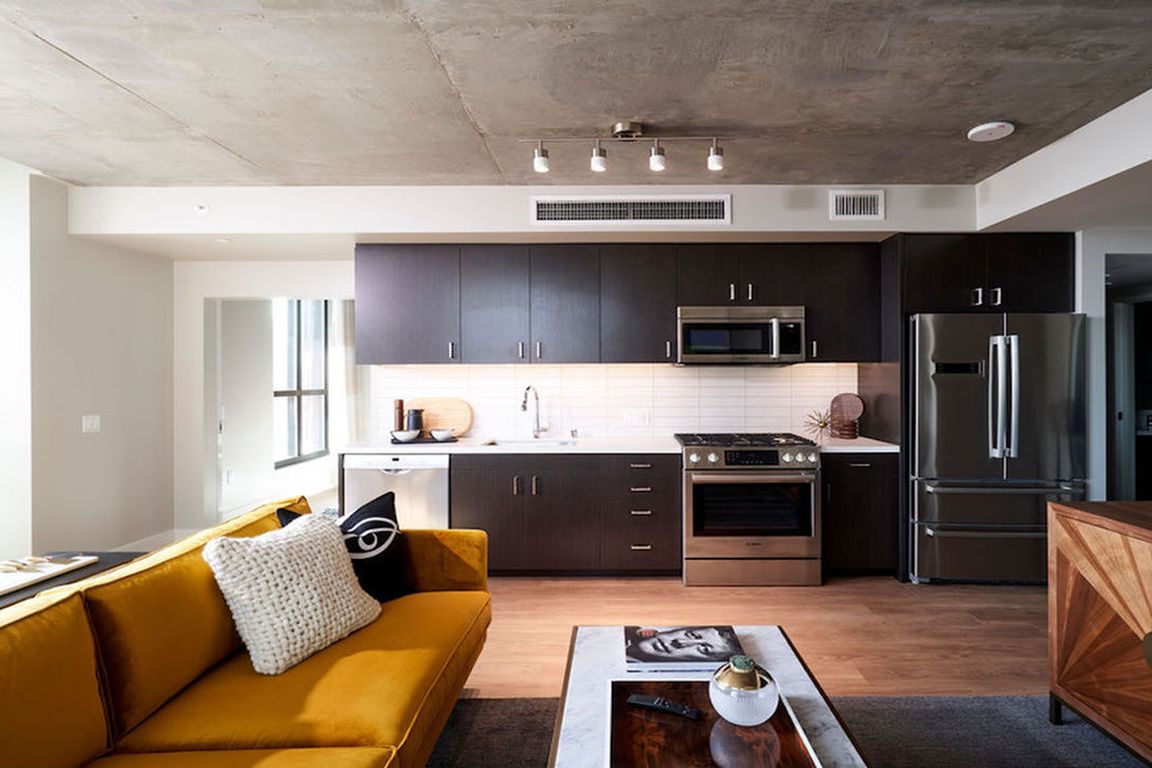 Beautiful apartment homes with espresso cabinetry, luxury stainless steel appliances, and subway tile backsplash