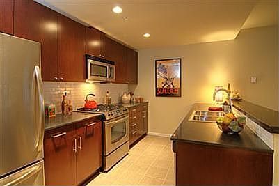 The chef's kitchen features high-end finishes including granite and stainless and all appliances are