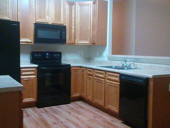 Kitchen featuring wood flooring ALL NEW APPLIANCES, bar stoo