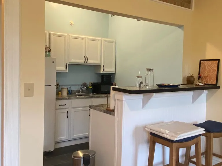 Kitchen breakfast bar looking out over living room