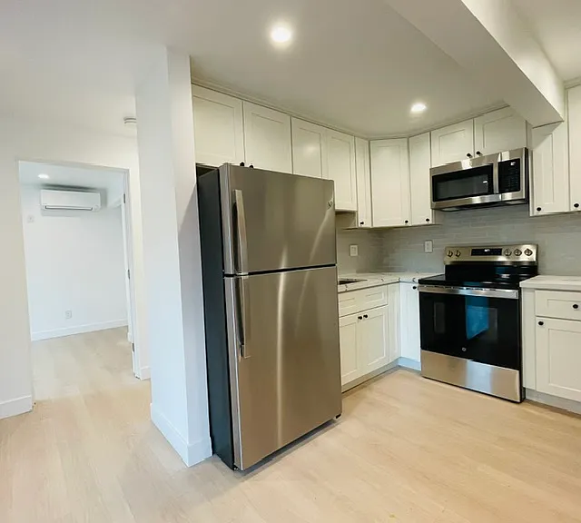 Kitchen with range, microwave, refrigerator, and dishwasher