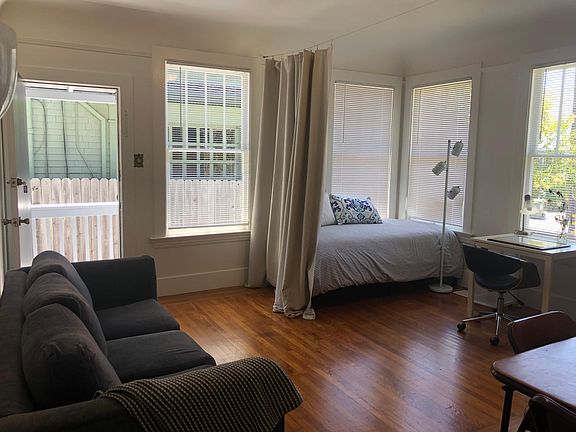 The living room shown with a second bed set up. There are 2 entry doors into this apartment, there is a possibility of using them to enter each room privately.