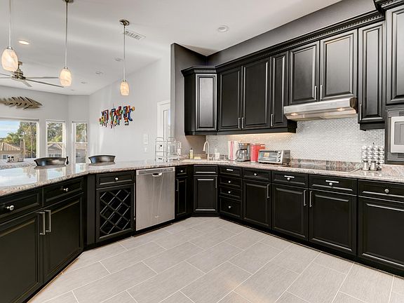 Kitchen features state-of-the-art appliances, including a double oven, large induction cooktop, spacious refrigerator with ice maker, & dishwasher. The attached prep area has a 2nd fridge and sink, making it perfect for everyday cooking and entertainment.
