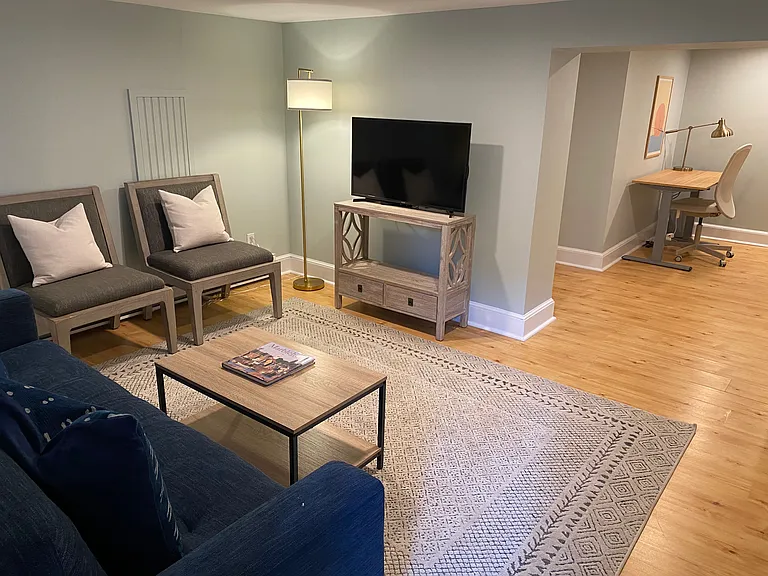 Finished basement with sleeper sofa, 40 inch TV and work desk