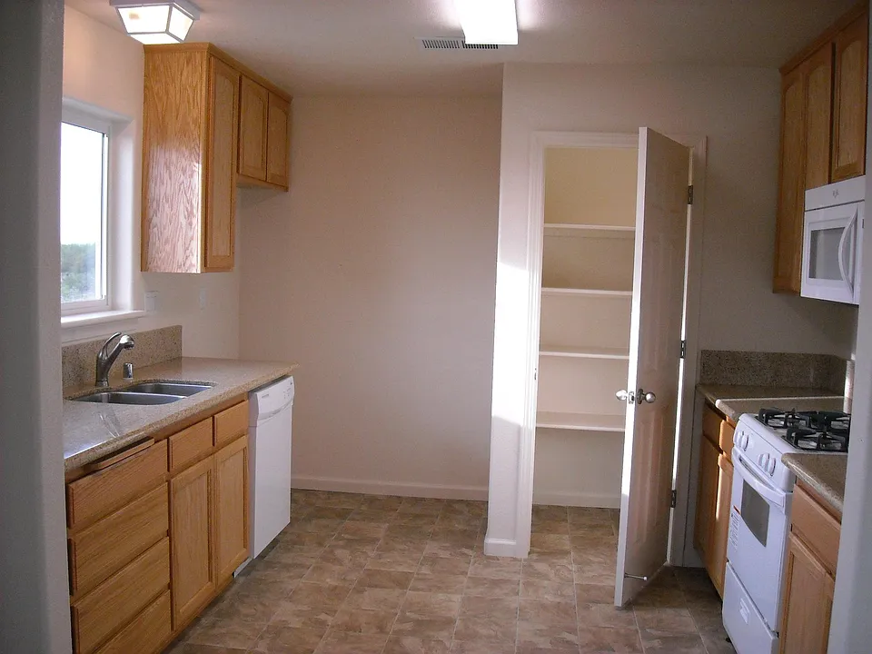 Kitchen with pantry, stove, microwave, stainless sink