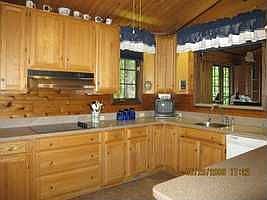 Kitchen has Corian counters, double oven [convection], ceramic cook top