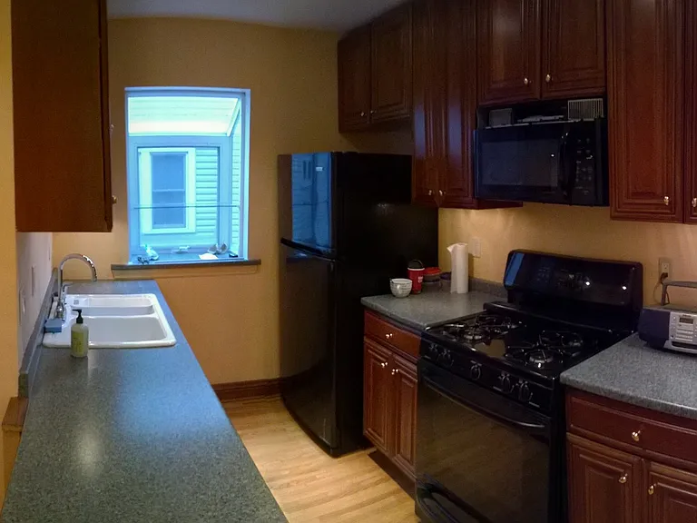 Gas stove and lower pull out cabinet drawers for ease of items stored and view of garden window