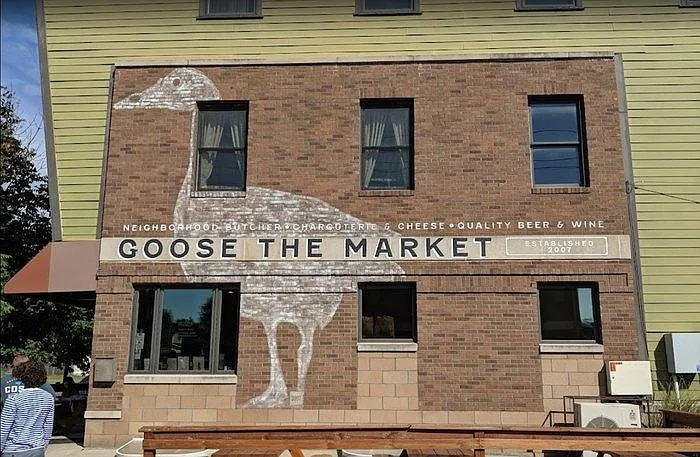2 doors down from Goose The Market