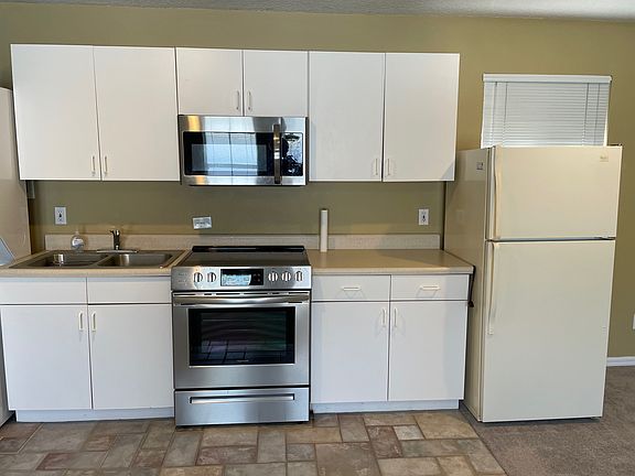 Full-sized Kitchen with range /oven, microwave oven and refrigerator.