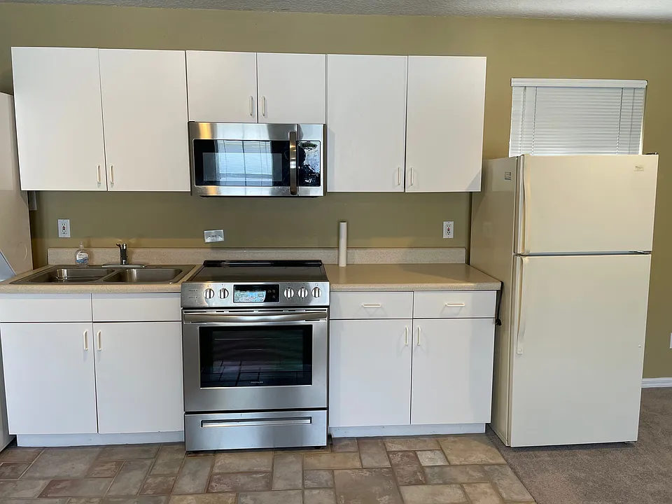 Full-sized Kitchen with range /oven, microwave oven and refrigerator.
