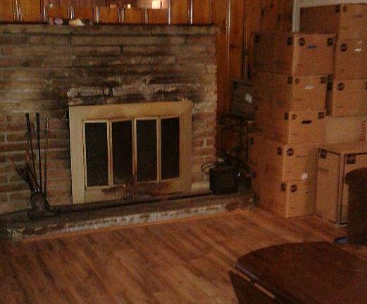 Working fireplace with an air ex changer and vintage knotty pine wanes coating.
