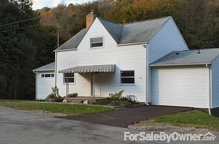 Rear view of home
						:
						New 25 x 12 foot deck, new pella windows, lofted ceilings
