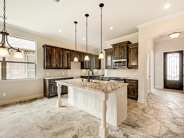 Kitchen with pendant lighting, eat in island and extensive tiled floor with diamond insets