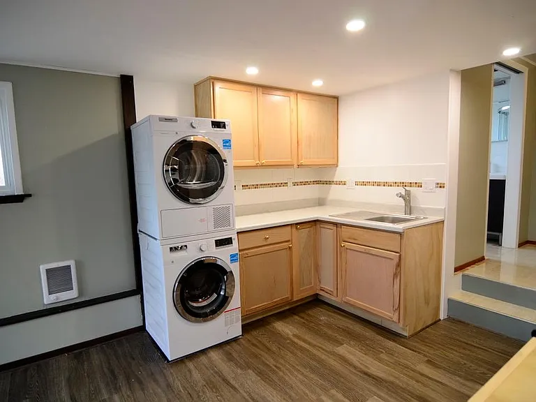 Newer washer/dryer, cabinets, counter, micro wave, refrigerator.