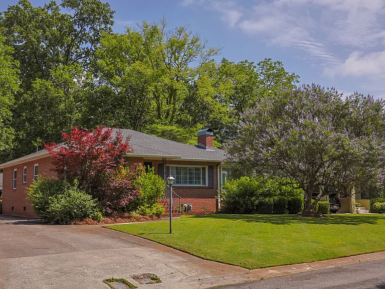 This beautiful brick home has mature landscaping including Japanese maples, a flowering dogwood, and a stunning chaste tree that blooms purple in the front yard.
