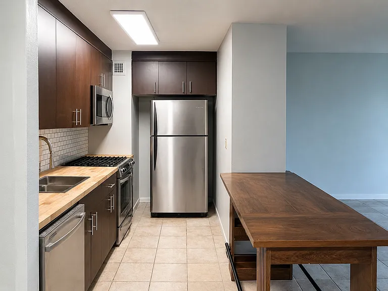 Another kitchen view with a gas range, dishwasher, microwave & refrigerator