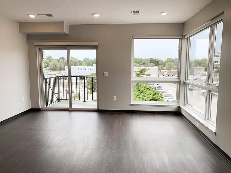 Bright, open living spaces with large windows and a private balcony bring in natural light and stunning views.