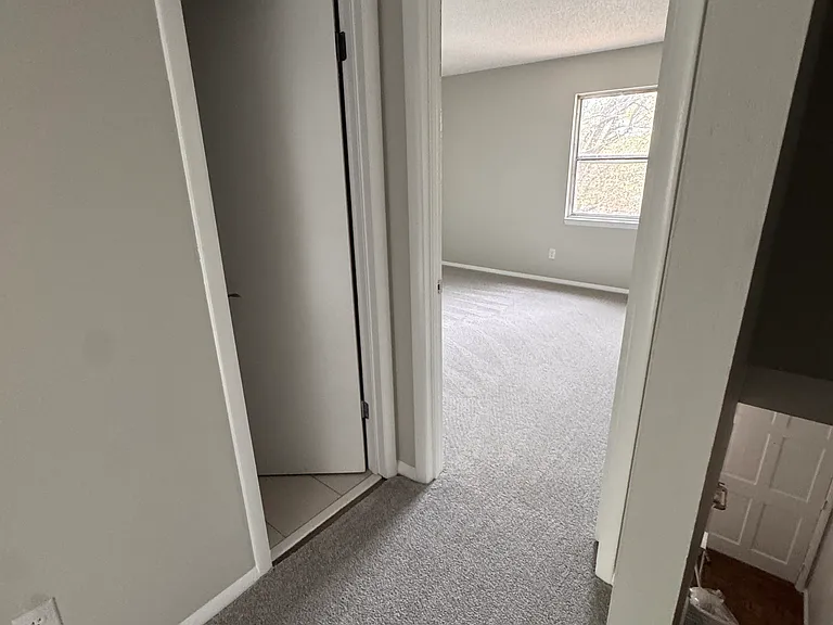 Upstairs hall looking to front with Half bath on left