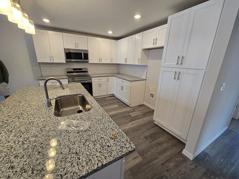 Kitchen with Brand New Stainless Appliances (fridge included - see other photos), brand new cabinets, and granite counters.