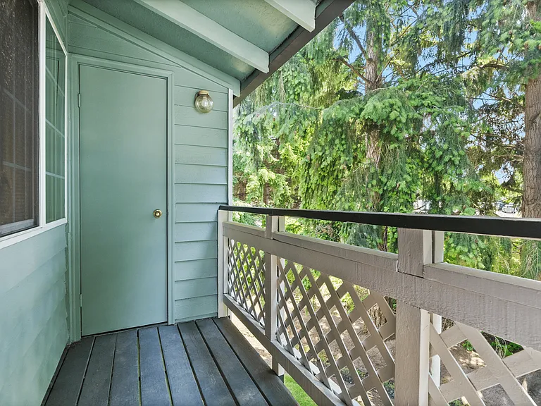 Apartment balcony with views overlooking the greenery surrounding the apartment community. Apartment balcony with views overlooking the greenery surrounding the apartment community.