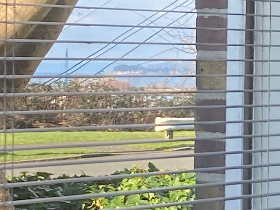 Peek-a-boo view of Port Gardner Bay and Jetty Island from LR window through Grand Avenue Park