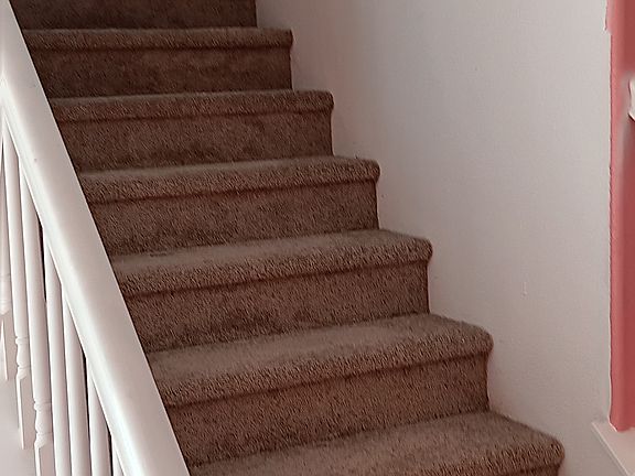 Stairs with landing, all new paint and new carpet inside.