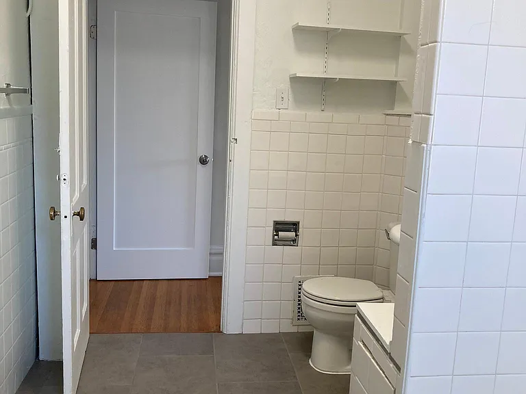 Large bathroom with storage closet.