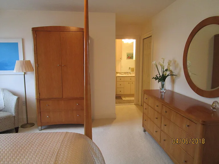 four-poster bedroom with door to ensuite bathroom