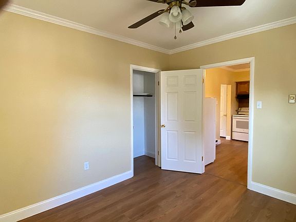 View from kitchen bathroom on the far left entrance to the laundry room next to it and entrance two bedroom beyond.